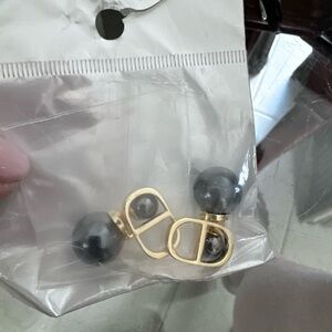 Brand new. Earrings with dark pearl